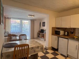 a kitchen with a table and chairs and a kitchen with a table and a kitchen at Zupan apartments in Ližnjan