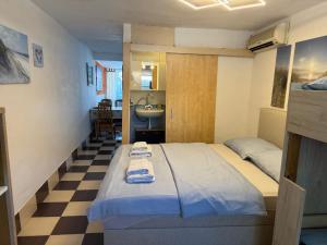 a bedroom with a bed with two towels on it at Zupan apartments in Ližnjan +26 photos