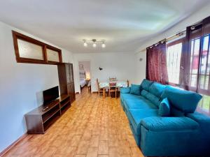 a living room with a blue couch and a table at La Xastra in Celorio