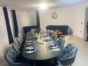 a dining room with a table and chairs with plates and flowers at Casa Runc in Şarul Dornei