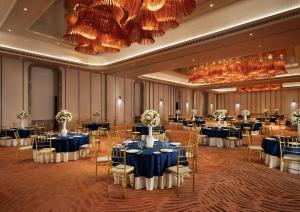 a banquet hall with tables and chairs in it at Taj Palace, Lucknow in Lucknow +62 photos
