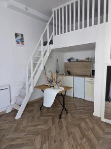 a dining room with a table and a staircase at RUFFEC 14 1D in Ruffec +1 photo