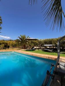 a view of a swimming pool with a chair next to it at Villa Etna Maison in Montargano