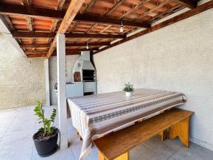 a large wooden table in a room with a table sidx sidx sidx at Casa c/ piscina e churrasqueira para até 6 pessoas in Limeiro