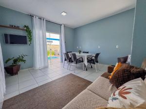 a living room with a table and a couch at Casa c/ piscina e churrasqueira para até 6 pessoas in Limeiro