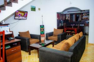 a living room with a couch and chairs at Casa Hikka Villa in Sinigama