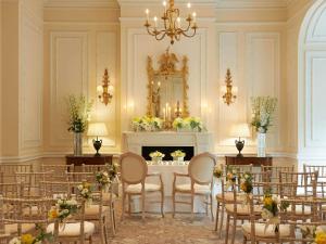 a room with tables and chairs and a fireplace at The Savoy in London +193 photos