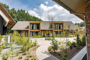 an external view of a house with a garden at Resort Valley in Wekerom