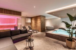 a living room with a couch and a swimming pool at Resort Valley in Wekerom