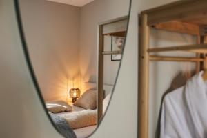 a mirror reflection of a bedroom with bunk beds at Resort Valley in Wekerom +82 photos