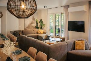 a living room with a couch and a table at Resort Valley in Wekerom