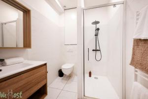 a bathroom with a shower and a toilet and a sink at Charmant cocon avec jacuzzi - Bordeaux Centre in Bordeaux