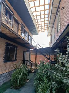a courtyard of a building with a balcony and plants at Asian Guest House in Bishkek