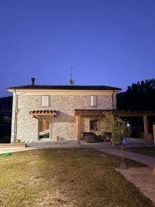 a large brick house with a yard in front of it at Vessa 3 in Selvapiana