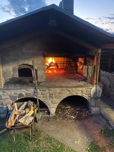 a large brick oven with a fire in it at Albergo Garni Villa Lory in Baselga di Pinè