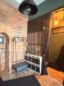 a room with a brick wall and a window at Independent charming studio in Gibel