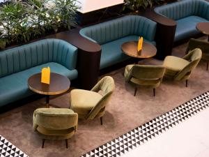a group of tables and chairs in a lobby at Swissotel Sydney in Sydney