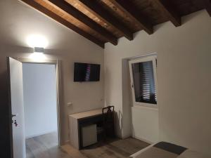 a living room with a fireplace and a window at La Cà de' mi Vecc in Fino Mornasco +23 photos