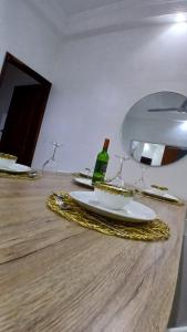 a table with a plate of food and a bottle of wine at Villa de 3 chambres avec jaccuzzi in Porto-Novo +39 photos