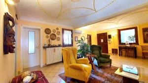 a living room with two chairs and a table at Cappone B&B in Morciano di Romagna