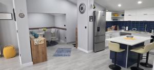 a kitchen with a refrigerator and a table and chairs at Villa View in Neum