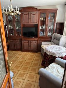 a living room with a tv and a couch and a table at Casa villada in Villada
