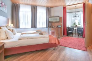 a bedroom with a large bed and a living room at Schlossberghotel Oberhof in Oberhof +82 photos