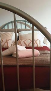 a bed with pillows and blankets on it at B&B D'Issy in Issy-lʼÉvêque