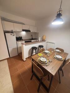 a kitchen and dining room with a wooden table and chairs at Condominio Villa Helios in Cuasso Al Monte +10 photos