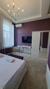 a bedroom with a large bed and a chandelier at Monro in Odesa