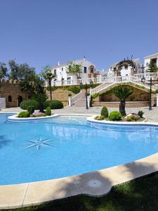 a large swimming pool with a star in the middle at Hacienda Los Manchones in Doña Mencía