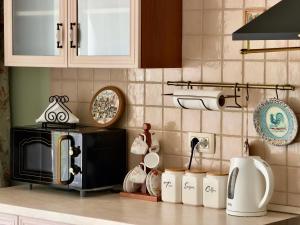 a kitchen with a counter with a microwave and a stove at GH Mountain & Bay View with POOL in Gornji Orahovac