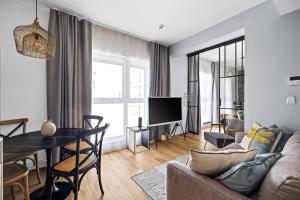 a living room with a couch and a table at Aparthotel City Break Plac Wolności 6 by INA in Poznań
