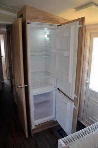 a white refrigerator with its door open in a room at Roselands caravan park, Nr Lands End, Cornwall in St. Just +128 photos