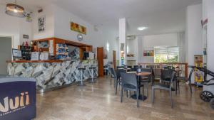 a dining room with tables and chairs in a restaurant at Hotel Kennedy in Lido di Savio
