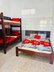 a bedroom with a bed and a bunk bed at Casa Alemao Águas Belas in Cascavel