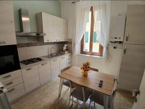 a small kitchen with a wooden table and a sink at Chimera 37's in Avezzano