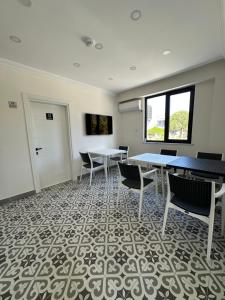 a conference room with tables and chairs and a door at Sevgi Hotel in Ezine