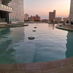 a swimming pool in the middle of a city at Darwin Harbour Sunset Views in Darwin