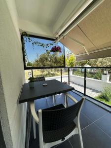 a table and chairs on the balcony of a house at Sevgi Hotel in Ezine