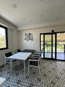 a dining room with a table and chairs at Sevgi Hotel in Ezine +23 photos