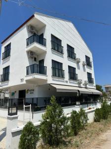 a white building with balconies on the side of it at Sevgi Hotel in Ezine