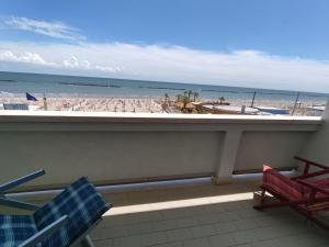 a balcony with a view of the beach and the ocean at FronteMare in Lido di Pomposa