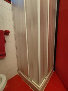 a shower stall in a bathroom with a toilet at FronteMare in Lido di Pomposa