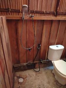 a bathroom with a hose hooked up to a toilet at Kafdarun Homestay in Dokkor