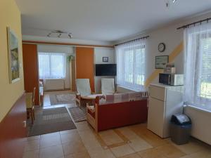 a living room with a couch and a microwave at Apartmány pod Suchým Vrchem - Dolní Morava - Buková hora - Orličky in Orličky