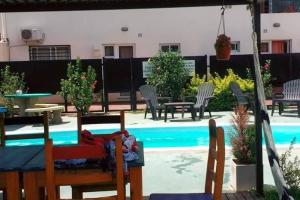 a patio with a table and chairs and a swimming pool at Ayalata del Rio in Colón