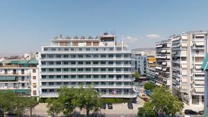 a large white building in a city with buildings at Xenophon Hotel in Athens