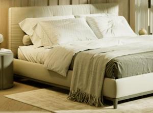 a large bed with white sheets and pillows at Laura Camp side Udawalawe in Udawalawe