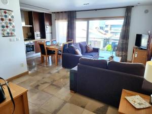 a living room with two couches and a dining room at Shell Bay Retreat in São Martinho do Porto